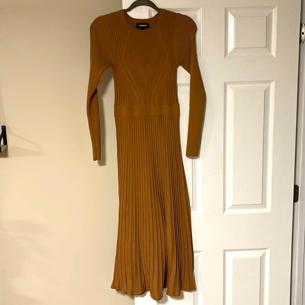 The perfect dress that features a soft sweater material and pleated skirt.
